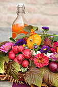 Colourful autumn arrangement of flowers and vegetables for harvest festival
