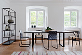 Delicate black furniture in Scandinavian-style dining room