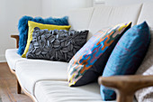 Colourful cushions with various textures on sofa