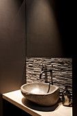 Stone sink against rustic stone wall