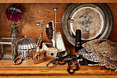 Vintage lady's accessories: jewellery box, perfume bottle, bracelets and necklaces in wooden cabinet