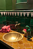 Oriental-style wall tiles in small green bathroom