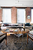 Living area in earth tones in loft apartment with brick walls