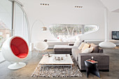 Designer furniture in living room of architect-designed, futurist house