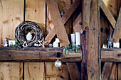 Christmas decorations on rustic wooden beams in barn