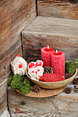 Crocheted Christmas decorations and red candles on rustic wooden steps
