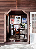 Glance into the dining room, pictures on a wood-clad wall