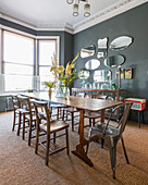 Vintage-style dining room in period interior with grey walls and bay window