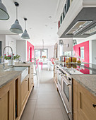 Modern country-house kitchen and dining room with hot-pink accents