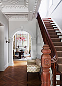Elegant staircase with oak parquet and arch