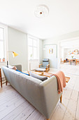 Bright, open-plan living room in retro Scandinavian style