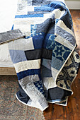 Blue and white quilt on bed