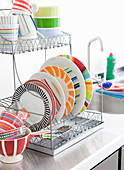 Brightly striped plates on drying rack