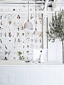 Botanical cards on the wall, olive trees and white desk