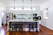 Open kitchen with glossy white fronts and center block