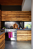 Open kitchen with wooden fronts and concrete floors