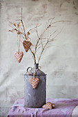 Heart-shaped pendants with waffle structure on branches in old metal can