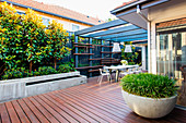 Modern back yard with terrace and seating under the pergola