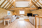 Living area below exposed roof structure in converted barn
