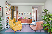 Retro armchairs in open-plan interior with pale blue floor