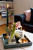 Flowers and candles arranged on tray in living room