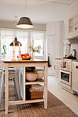Island counter with open-fronted shelves in rustic kitchen