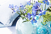 Delphinium in light blue glass vases