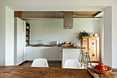 L-shaped, fitted kitchen with counter in open-plan interior