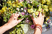 Hands arranging bunch of wildflowers