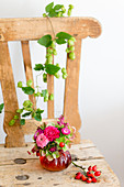 Late summer bouquet with zinnias on wooden chair
