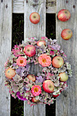 Late-summer wreath of hydrangeas, zinnias and apples