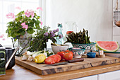 Fresh vegetables on chopping board in kitchen