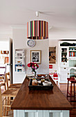 Striped ceiling lamp in open-plan country-house-style interior