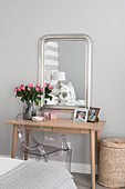 Wooden dressing table, Ghost chair and simple silver-framed mirror
