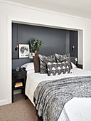 Double bed with head in dark-painted alcove