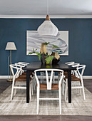 Table and chairs in dining area with blue wall