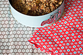 Cake in springform pan and handmade oilcloth cake bag