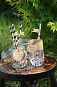 Hand-crafted tags on drinking glasses with paper straws