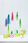 Colourful miniature Christmas trees made from painted bottle brushes