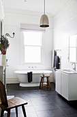 Freestanding bathtub in a simple bathroom in black and white