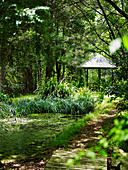 Lush green, natural garden with a pavilion