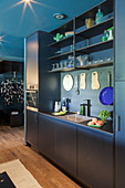 Modern fitted kitchen in petrol blue and charcoal