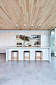 Bar stool at kitchen island in modern open kitchen