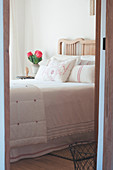 View through open door into country-house bedroom