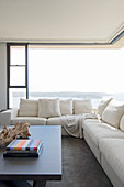 Cream sofa in front of corner window with panoramic view