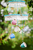 Mobile made from embroidery frames, lace ribbon and colourful cups