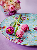 Pink tulips on pale-blue floral plate
