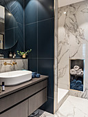 Dark blue tiles and marble surfaces in classic bathroom