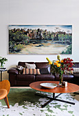 Landscape painting above the leather sofa in the living room