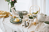 Table decorated in casual style and natural shades for Easter breakfast